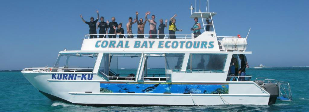 Coral Bay Eco Tour boat with swimmers waving