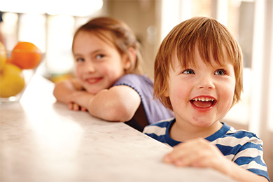 Kids smiling in their family home