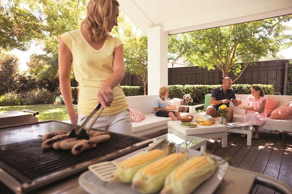 Mum cooking a bbq for her husband and kids